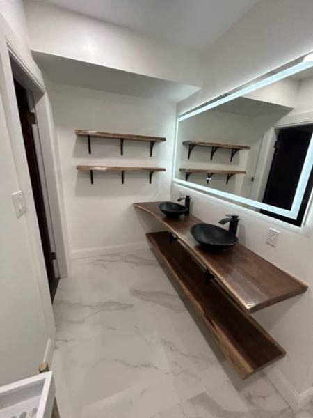 Walnut floating shelves in a bathroom