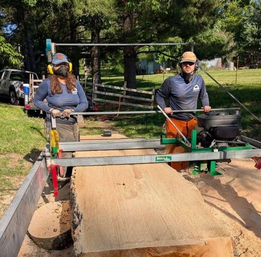 Evan and Carolina sawing a log on the Twin Oak sawmill