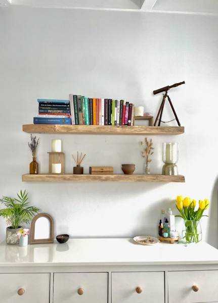 Live-edge floating shelves on a white wall