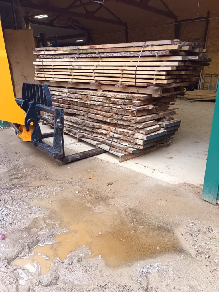 Stickered live-edge slabs and lumber stacked in the shop