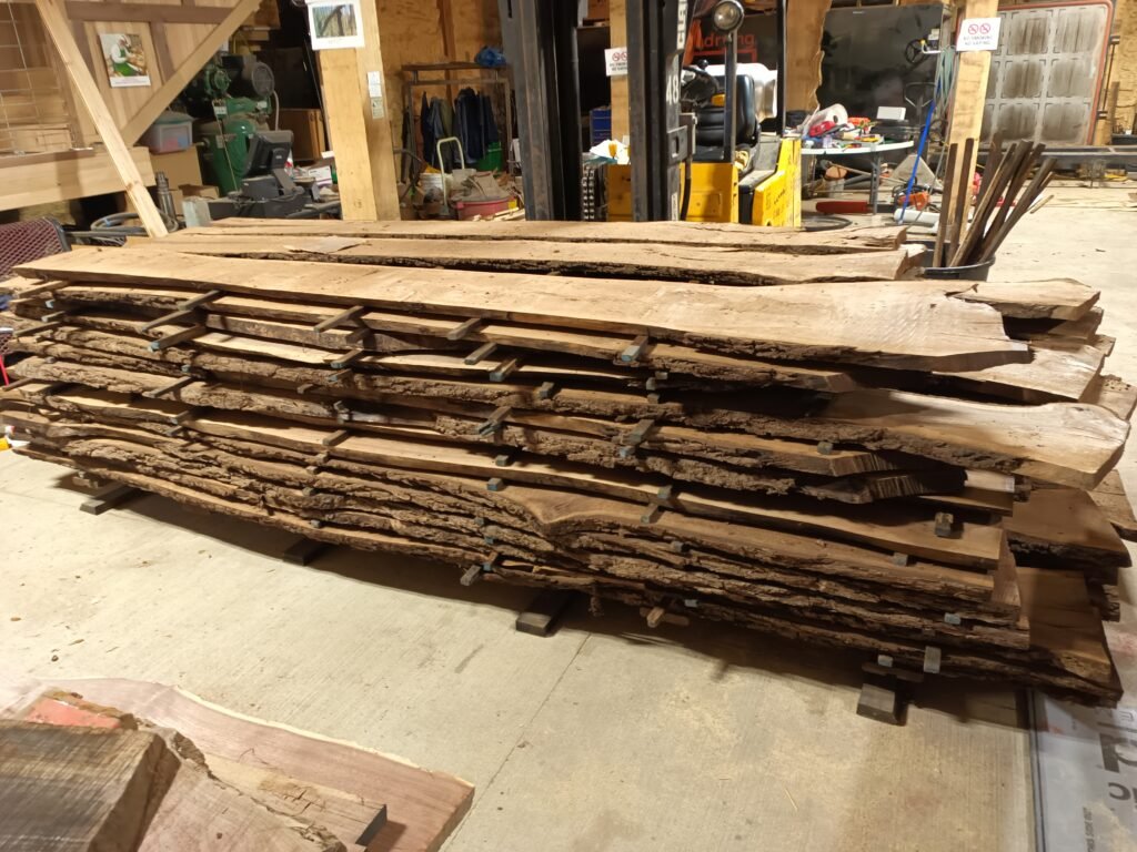 Stack of stickered walnut slabs in the Twin Oak shop